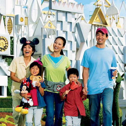 A family of four is smiling and enjoying their day at a theme park, with a whimsical, castle-like background behind them.